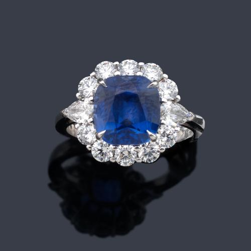 Anillo con zafiro talla 'cushion' de aprox. 3,99 ct con orla de diamantes talla brillante y dos talla perilla de aprox. 1,37 ct en total.