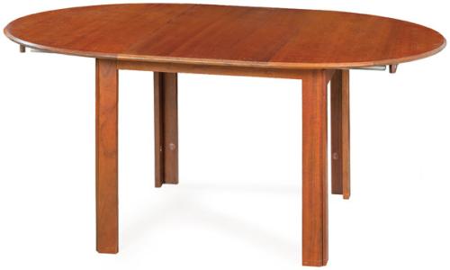  Mesa de comedor extensible de BIOK en madera de teca, con tapa circular sobre patas rectas.