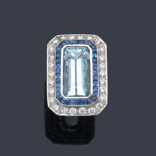  Anillo con aguamarina talla rectangular de aprox. 9,00 ct con doble orla de zafiros calibrados de aprox. 2,00 ct y brillantes de aprox. 1,50 ct en total.