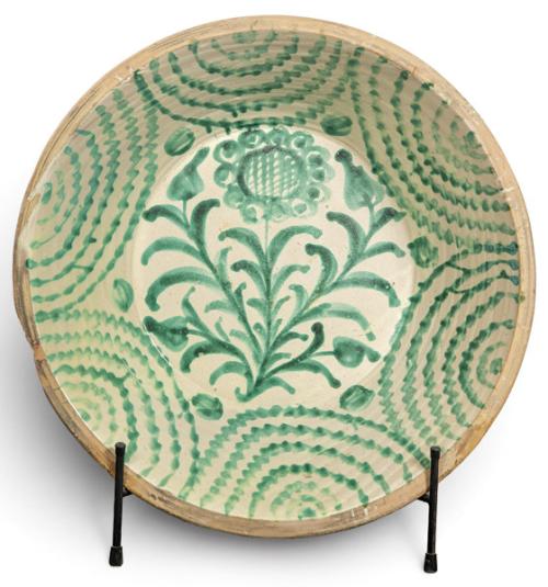  Lebrillo en cerámica esmaltada de Fajalauza sobre fondo blanco cremoso, con decoración en verde de flor estilizada de centro reticulado, tallos, hojas y motivos semejantes a capullos en el asiento.