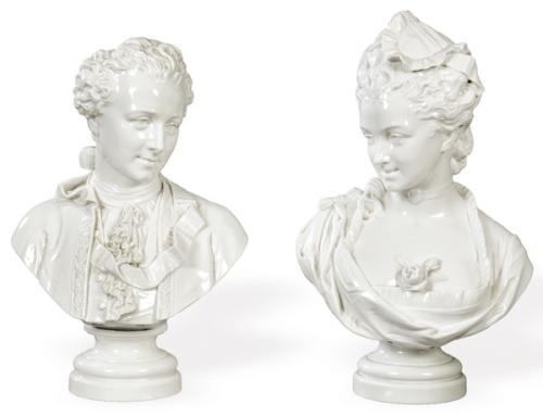  Pareja de bustos masculino y femenino en porcelana blanca vidriada, sobre peanas circulares molduradas. Representan figuras con indumentaria de inspiración europea del siglo XVIII. Busto masculino con firma ilegible.